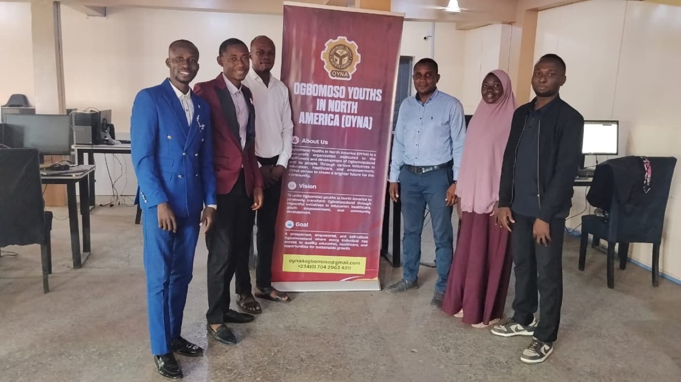 OYNA members standing beside an empowered youths awards banner