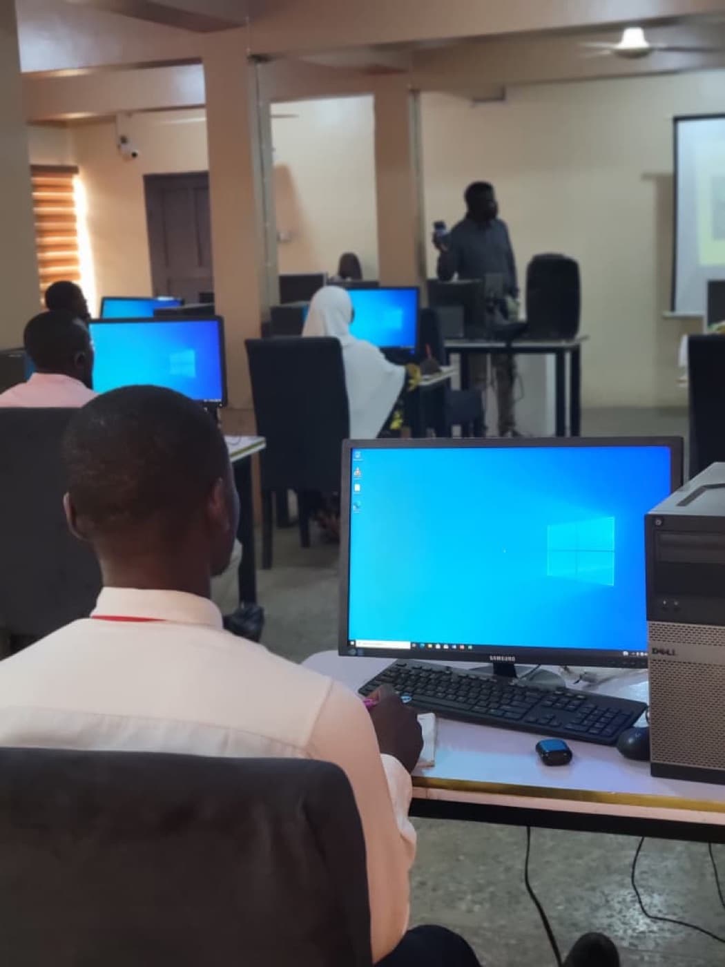 Young people learning computer skills at an OYNA training session